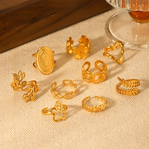 Detailed close-up of 9-piece gold stainless steel ring set with floral and leaf designs