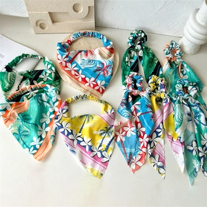 Tropical coconut tree printed fabric headbands and hair accessories on a white surface
