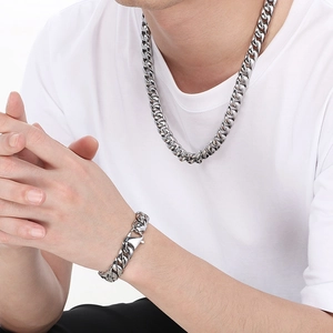 Polished 12mm silver Cuban link necklace and bracelet set for men on a model