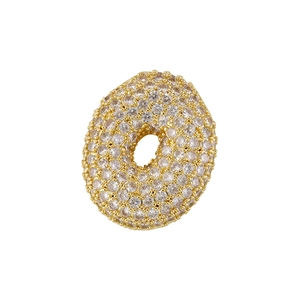 Macro view of gold-plated letter O pendant fully pavé set with white cubic zirconia