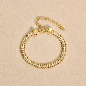 Detailed macro view of double-row 18K gold-plated bracelet with white zircon inlay