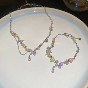 Detailed set of silver chain butterfly necklace and bracelet with colorful crushed stones