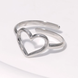 Macro shot of silver minimalist heart-shaped open ring with adjustable band detail