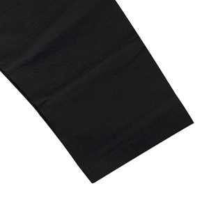 Detailed close-up of double-stitched hem and texture on black linen blend fabric