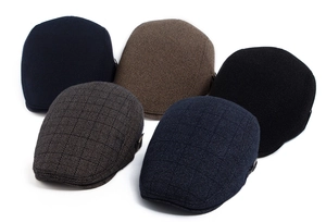 Flat lay of retro wool beret hats with thick twill lining and metal buckle details