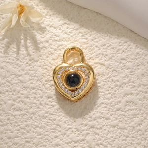 Macro shot of gold heart pendant with center stone and encircling small zircon stones