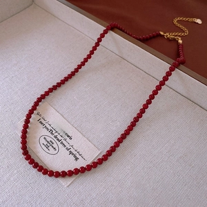 Detail of vintage red pearl necklace with gold heart charm and adjustable extension chain