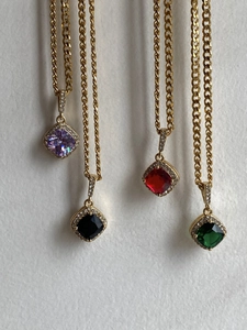 Detail of square zircon pendants in four colors with gold plated twisted chains