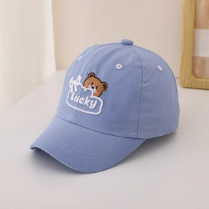 Detailed close-up of light blue cotton kids baseball cap with brown bear embroidery