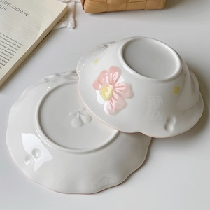Off-white ceramic breakfast set with embossed pink floral bowl and cherry pattern plate
