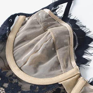 Lace bralette detail showing sheer mesh lining and black floral eyelash lace trim