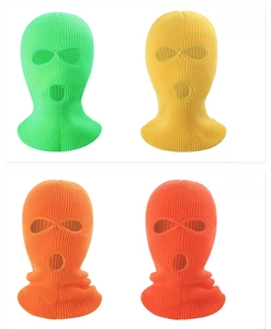 Detail of neon-colored knitted 3-hole balaclavas showing vibrant ribbed texture and design