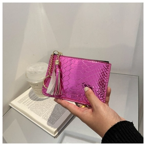 Pink metallic snakeskin coin purse featuring a gold zipper and stylish tassel keychain