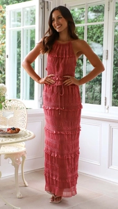 Detailed view of brick red pleated chiffon fabric and tiered ruffle trim on maxi dress