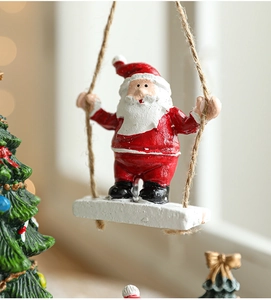 Detail showing a miniature Santa Claus on a swing with rustic hanging rope