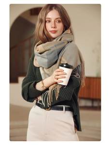 Detail view of the thick plaid scarf with soft gray and beige fringe tassels decoration
