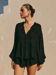Detail of black tiered long sleeve top and shorts set with textured breathable fabric