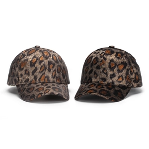 Close-up of leopard print baseball caps showing metallic shimmer and 6-panel structure