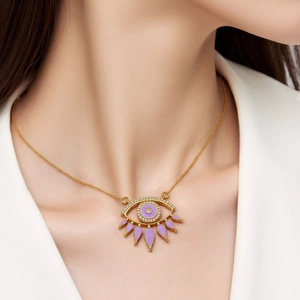 Detailed shot of an evil eye pendant with purple enamel and zircons on a gold chain