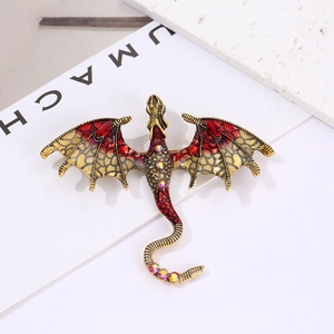 Vintage winged dragon brooch in antique gold and red enamel with sparkling rhinestones