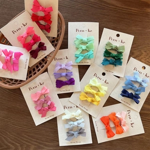 Detailed set of colorful grosgrain ribbon bow hair clips on premium display cards