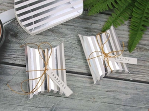 Silver striped pillow box with gold string and Thank You tag on vintage wood