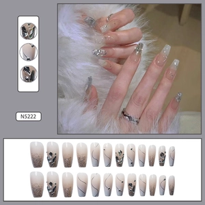 Detail view of silver glitter gradient press-on nails with rhinestones and line art
