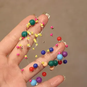 Macro detail of colorful resin beads on jewelry wire for vintage circular earrings