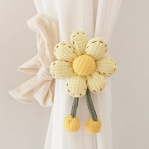 Macro shot of yellow flower curtain tieback with green stems on white fabric