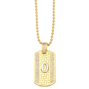 Detailed macro view of golden dog tag pendant with silver letter O and small zircon stones