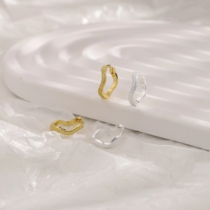 Detail view of S925 sterling silver wavy hoop earrings in gold and silver finishes