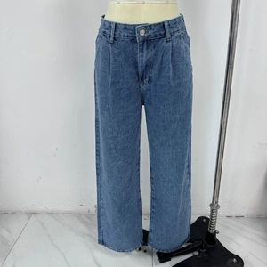 Detail view of high-waisted wide leg blue wash denim jeans on a studio mannequin