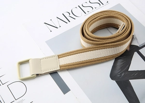 Detailed close-up of khaki and white striped canvas belt with double ring buckle