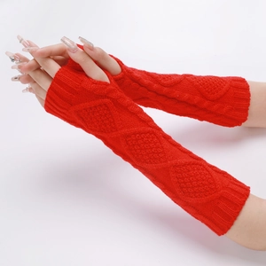 Detail of red cable-knit arm warmers with diamond pattern in soft winter wool
