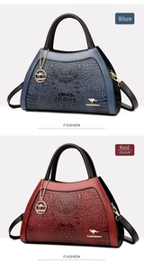 Detail view of blue and red crossbody bags featuring embossed crocodile texture and metal charms