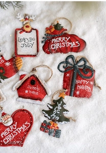 Flat lay of vintage iron Christmas ornaments with festive text on a snowy background
