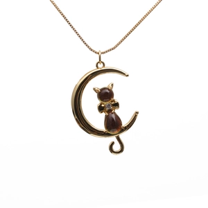 Golden moon and cat crystal pendant necklace with brown gemstone and bow detail