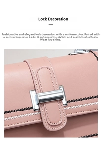 Detail of pink lychee leather bag featuring a silver metal lock and stitched embroidery