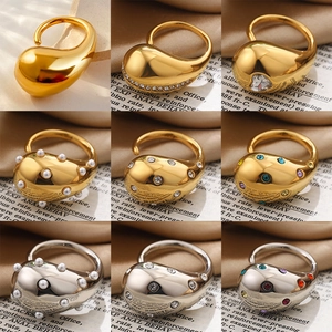 Water drop zircon rings in gold and silver finish on vintage newspaper background