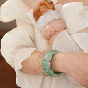 Detailed close-up of marble-textured acrylic resin wide bangles in multiple colors