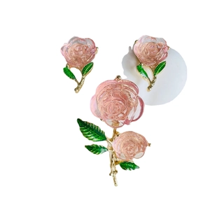 Vintage pink enamel rose jewelry set including floral stud earrings and brooch pins