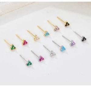 Macro shot of 12 pairs of S925 silver clover stud earrings in various colorful zircons