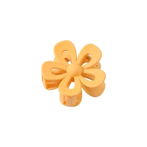 Detail of yellow flower hair claw clip with matte finish and secure metal spring