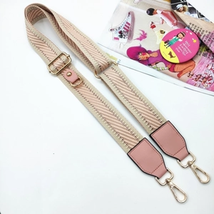 Detail of adjustable woven phone strap with pink wave pattern and gold metal hooks
