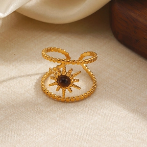 18k gold plated stainless steel sunburst ring with tiger eye stone on textured fabric
