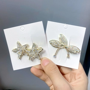 Elegant gold-plated star and dragonfly hair clips with sparkling crystal rhinestones