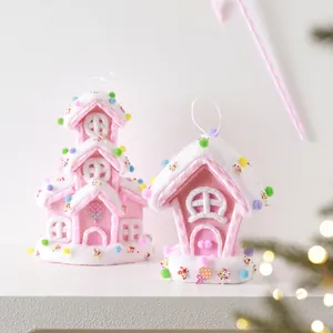 Pink glitter gingerbread candy house ornaments with white snowy roofs for Christmas trees