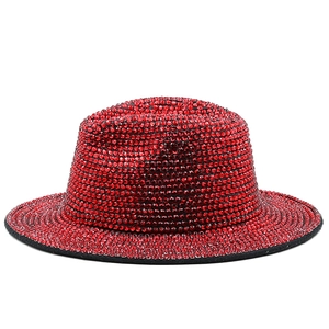 Detailed view of handmade red rhinestones on a stylish flat top wool felt jazz hat