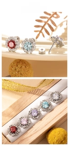 Detailed close-up of colorful heart-and-arrow zircon flower stud earrings in titanium steel
