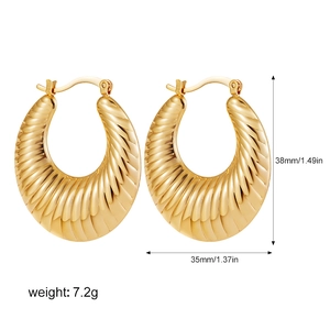 Detail view of 14k gold plated textured hoop earrings measuring 38mm with shell patterns